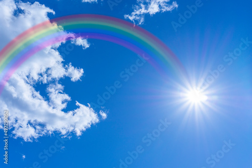 Bright blue sky with rainbow and sunshine_blue_21