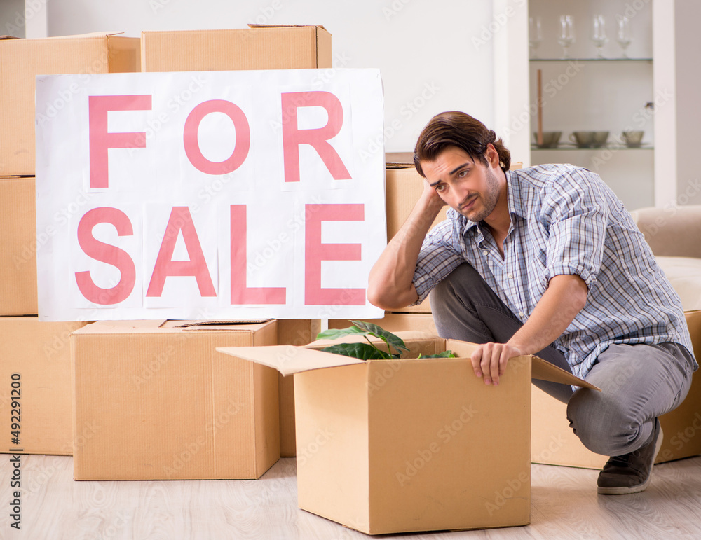 The young man offering home for sale and moving out The young man offering home for sale and moving out