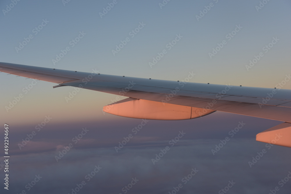 airplane wing with anti-shock bodies reflecting sunset light, feel nostalgia airplane wing with anti-shock bodies reflecting sunset light, feel nostalgia