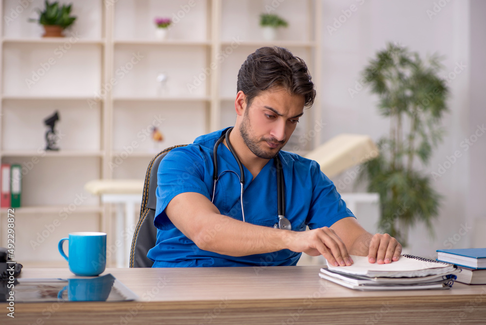 Young male doctor working in the clinic Young male doctor working in the clinic