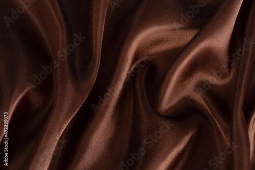 Smooth elegant brown silk or satin texture can use as abstract background.