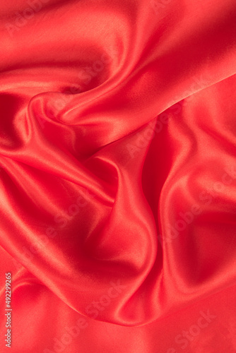 Abstract red silk fabric texture background. Cloth soft wave.