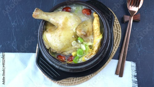 Ginseng chicken soup or Samgyetang, Koreans traditional food chicken stuffed with rice, ginsenga popular stamina food in summer. photo