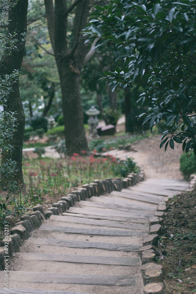Stone wall path connecting the gardens in the park Stone wall path connecting the gardens in the park