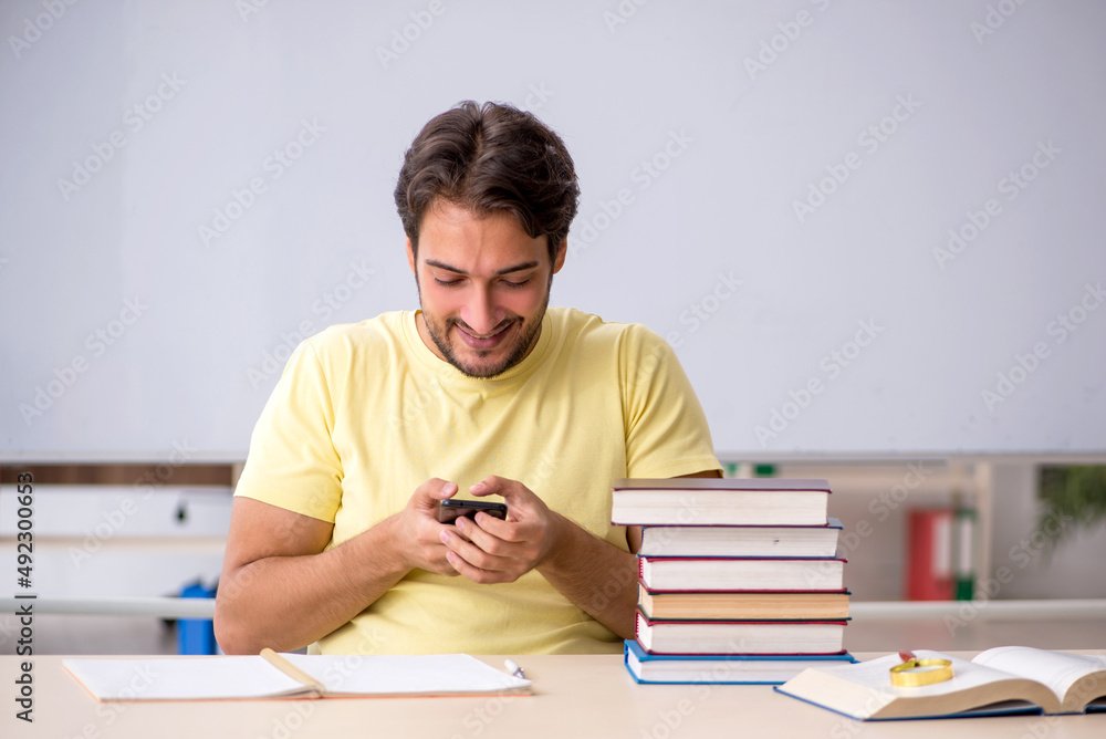 Young male student preparing for exams in the classroom Young male student preparing for exams in the classroom