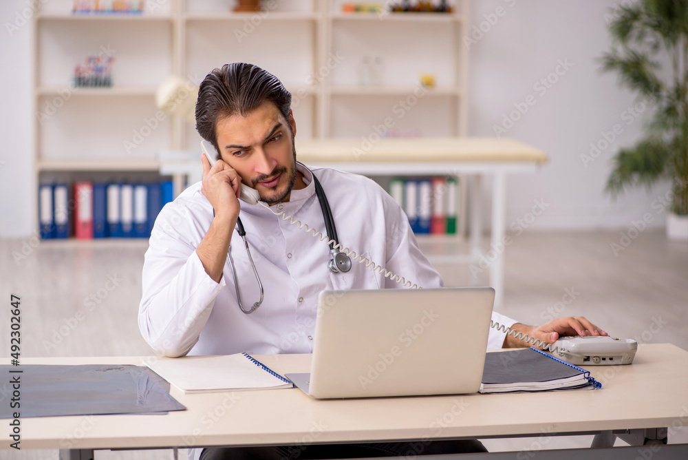 Young male doctor in telemedicine concept Young male doctor in telemedicine concept