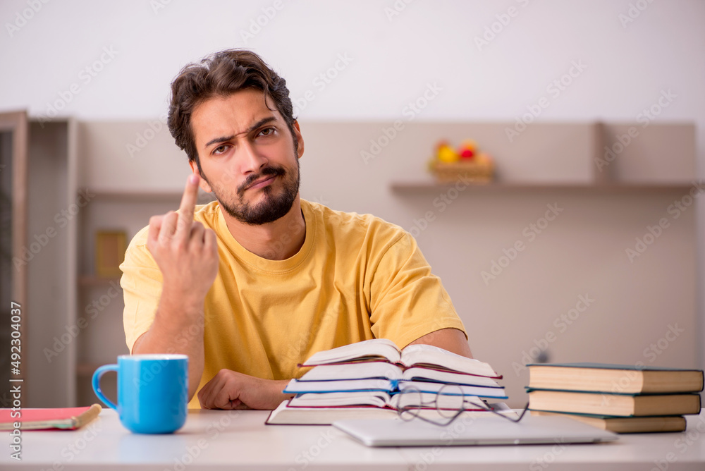 Young male student preparing for exams at home Young male student preparing for exams at home