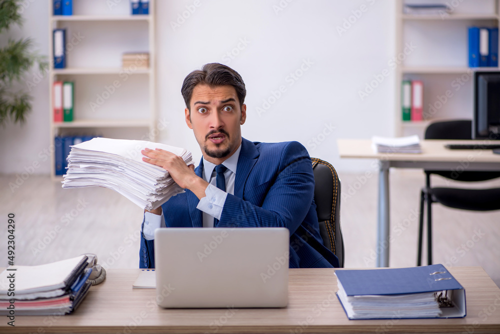Young male employee working in the office Young male employee working in the office