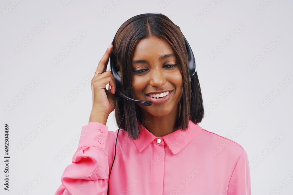Shes a dedicated customer service representative. Studio shot of an attractive young female customer service representative wearing a headset against a grey background. Shes a dedicated customer service representative. Studio shot of an attractive young female customer service representative wearing a headset against a grey background.