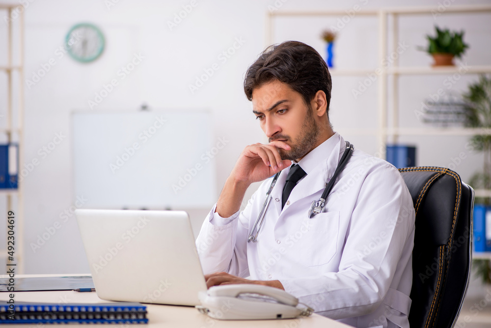 Young male doctor in telemedicine concept Young male doctor in telemedicine concept