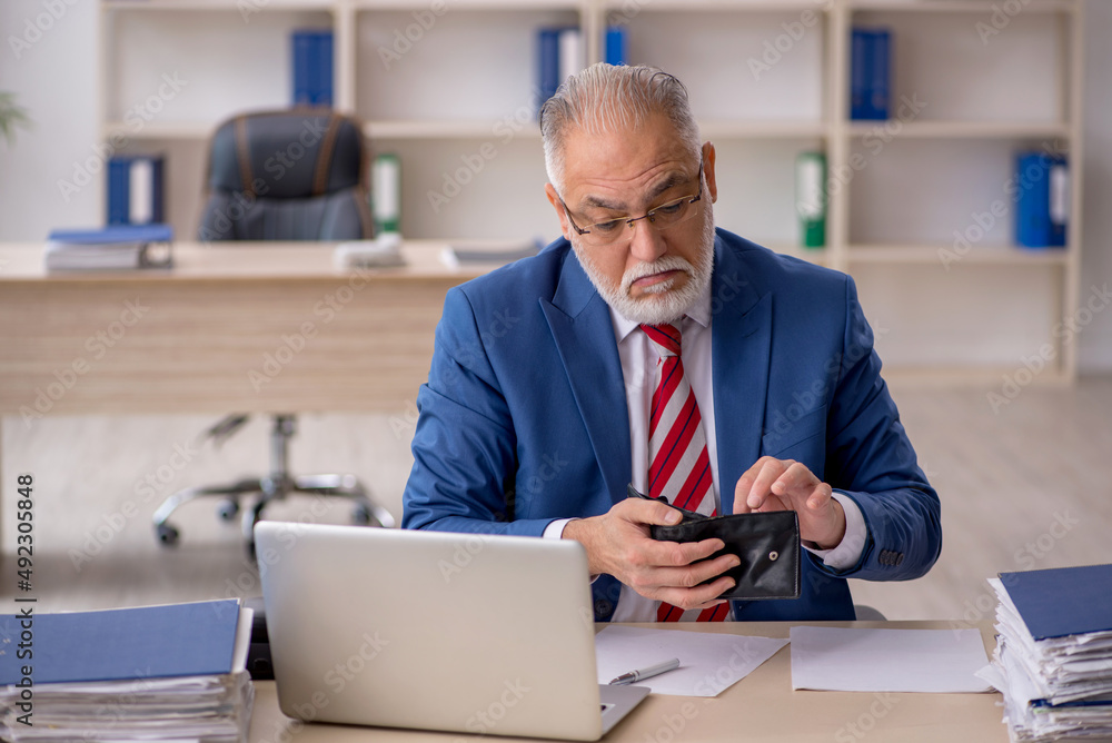 Old male employee in remuneration concept Old male employee in remuneration concept