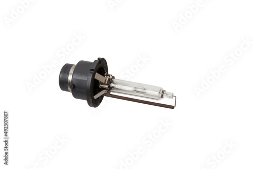 Automotive electric parts - New white 12v xenon headlight car lamp on the white background - gas discharge lamp. Spare parts auto catalog