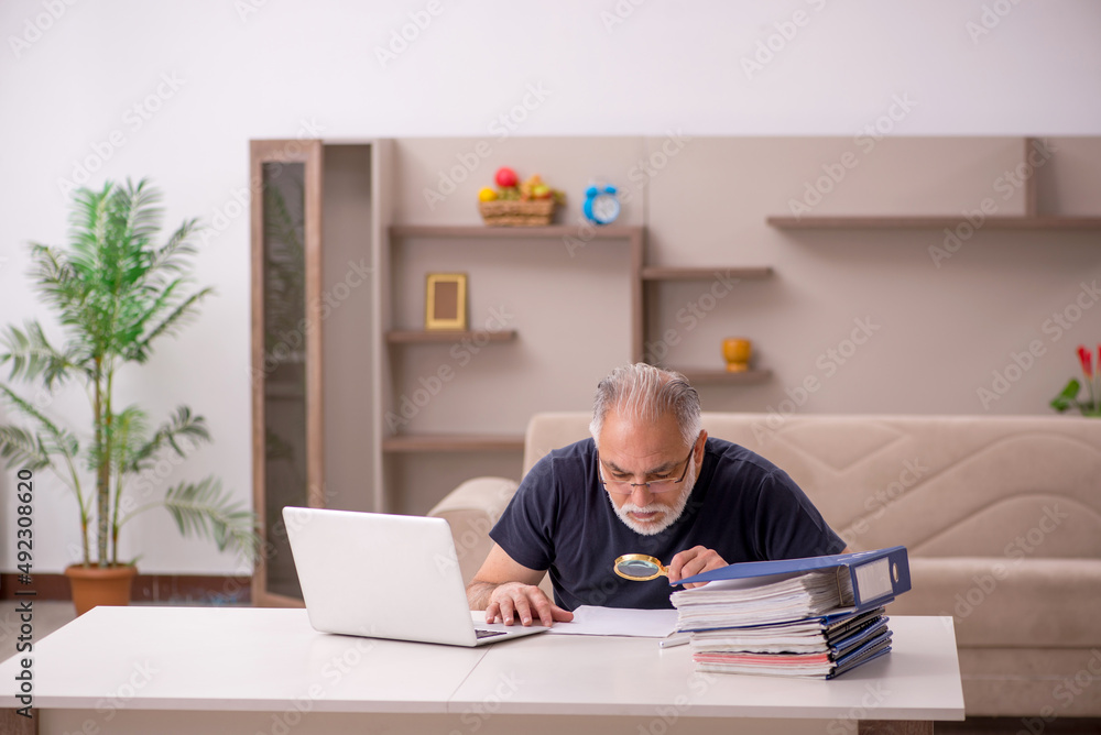 Old male employee working from home during pandemic Old male employee working from home during pandemic