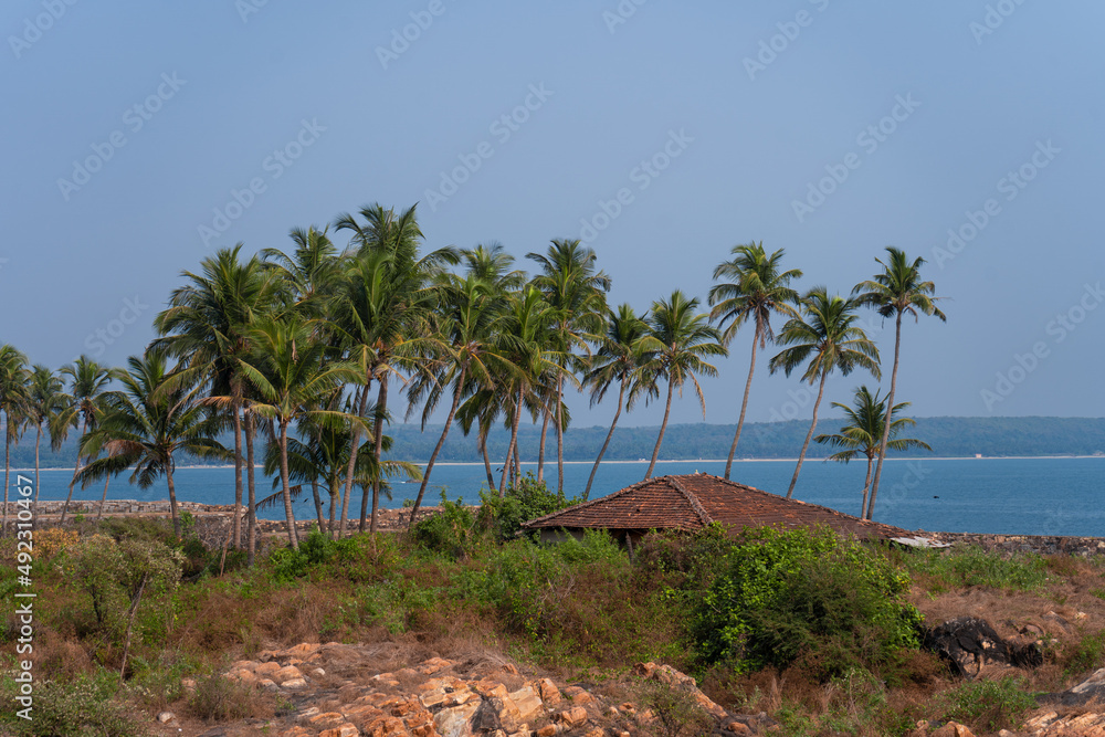 Red hut on the beach with the coconut trees 
