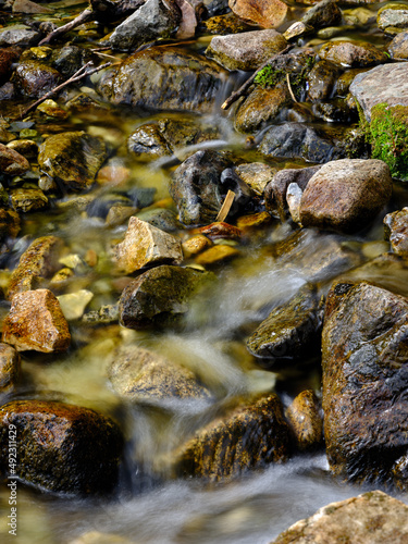 Small stones in a flowing stream with blurred water