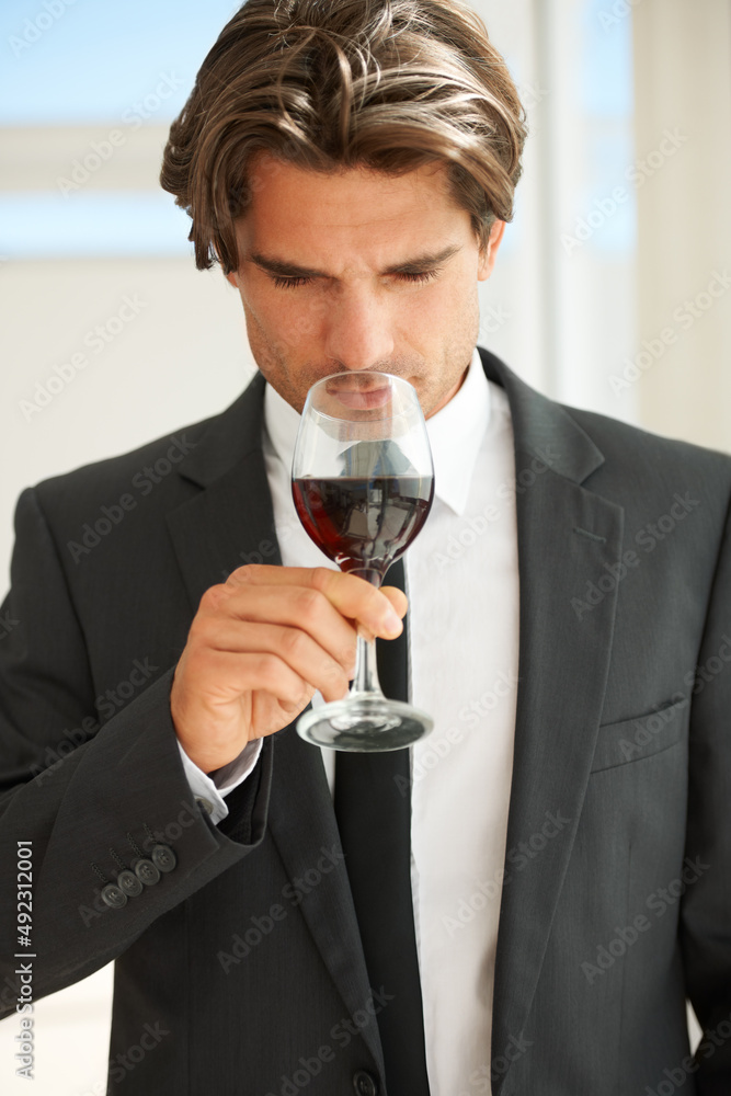 Fruity yet playful. A handsome wine connoisseur enjoying a glass of red wine. Fruity yet playful. A handsome wine connoisseur enjoying a glass of red wine.