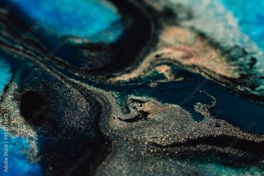 Obraz premium Alcohol ink art. Abstract design. Colorful paint background. Blue gold black colors blend.
