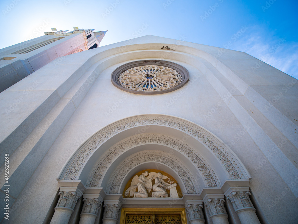 Obraz premium Golden Door with Roman Columns in Front of t.Louis Marie de Montfort Church