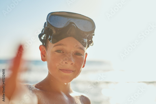Ready to explore ocean. Cropped shot of a young boy enjoying a day at the beach. © Katleho S/peopleimages.com