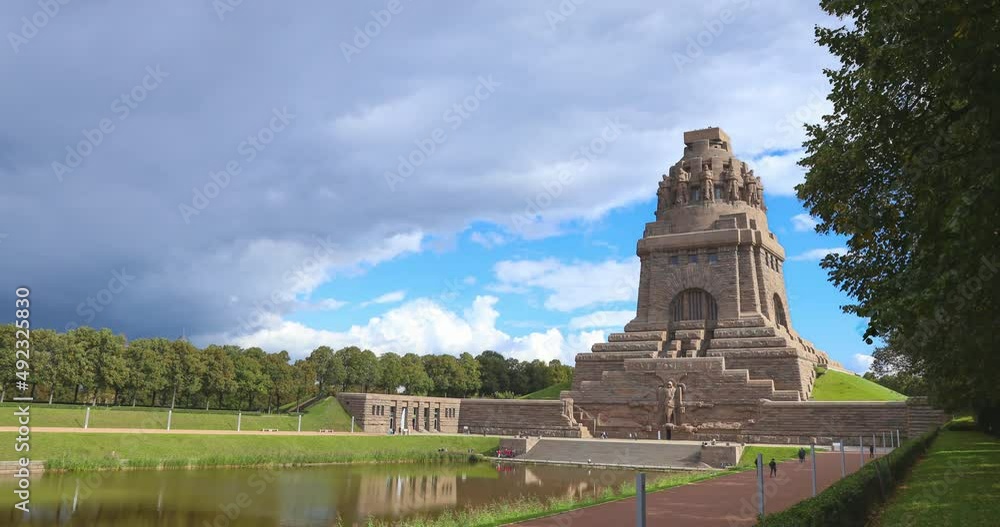 Leipzig, Germany - September 23, 2021: Time lapse at the monument of the battle of nations in the saxony city of Leipzig. Napoleon's downfall began at this point. The building behind a small pond Leipzig, Germany - September 23, 2021: Time lapse at the monument of the battle of nations in the saxony city of Leipzig. Napoleon's downfall began at this point. The building behind a small pond