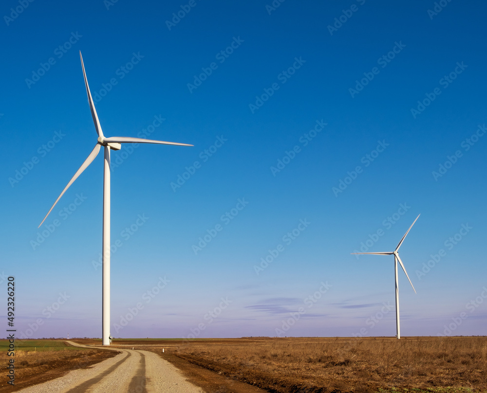 windmills in the field during the day, environmentally friendly and safe production of electricity windmills in the field during the day, environmentally friendly and safe production of electricity