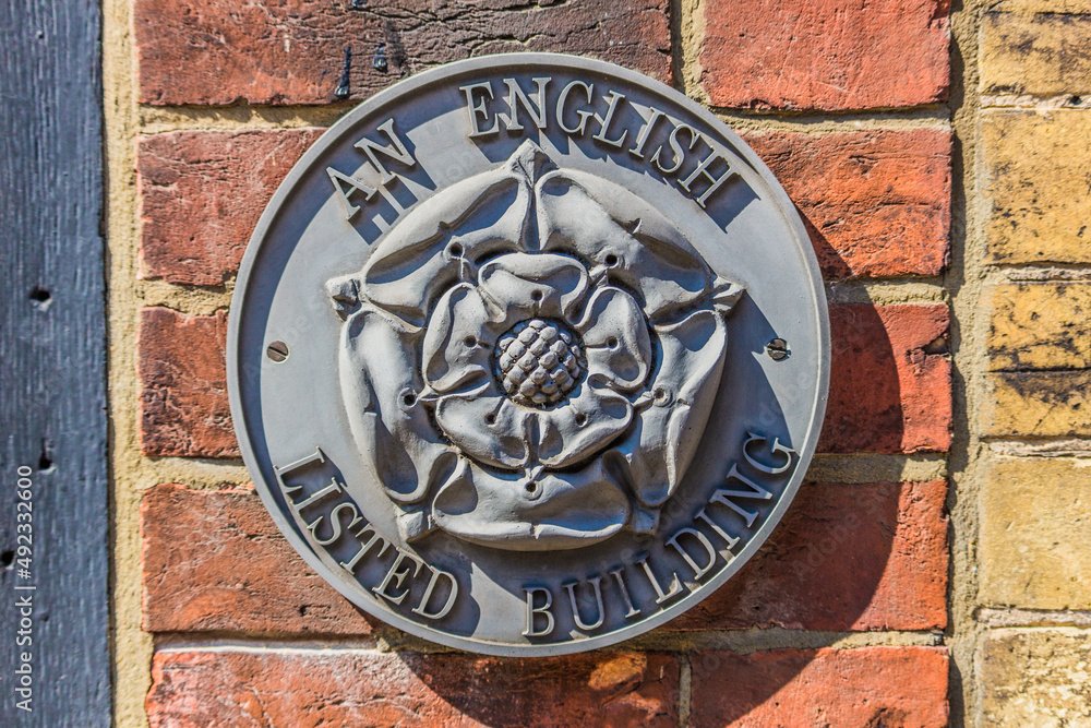English Heritage Badge mounted to a brick wall.