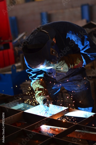 A welder works at a factory