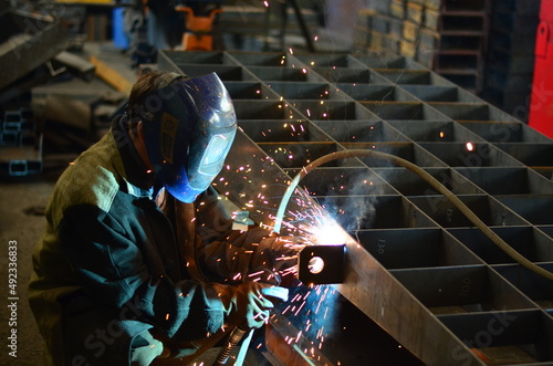 A welder works at a factory