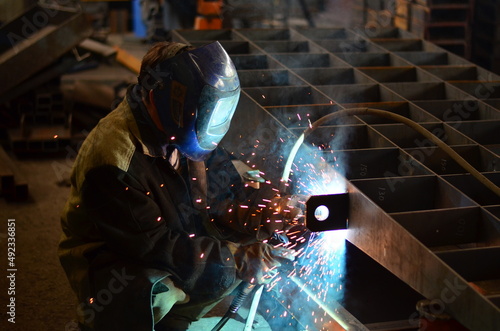 A welder works at a factory