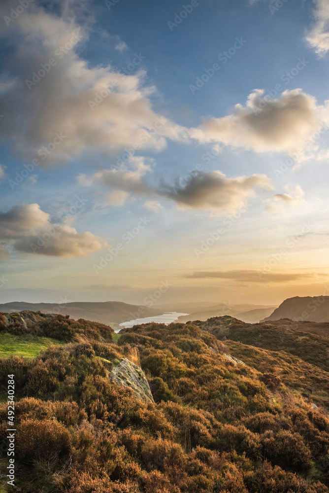 Majestic Autumn sunset landscape image from Holme Fell looking towards Coniston Water in Lake District