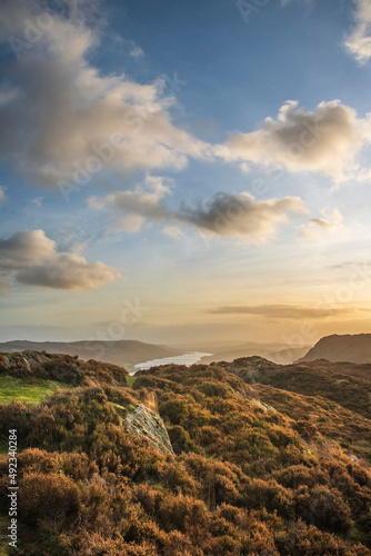 Majestic Autumn sunset landscape image from Holme Fell looking towards Coniston Water in Lake District