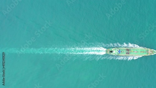 oil tanker ship full speed sailing in green sea aerial top view from drone 4k video  photo