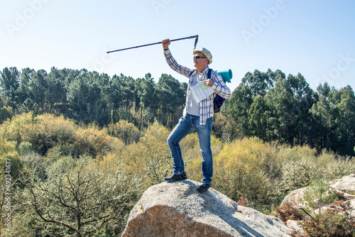 mountaineer with backpack on top of the hill