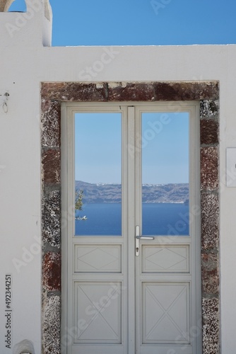 A typical door in Santorini with a breathtaking view of the Aegean Sea and the blue sky