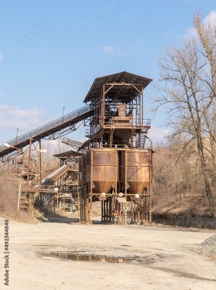 An old gravel quarry. Mining and quarrying equipment. Granite gravel stone open pit mining. An old gravel quarry. Mining and quarrying equipment. Granite gravel stone open pit mining.