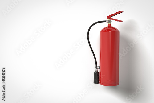 Fire extinguisher handing on wall photo