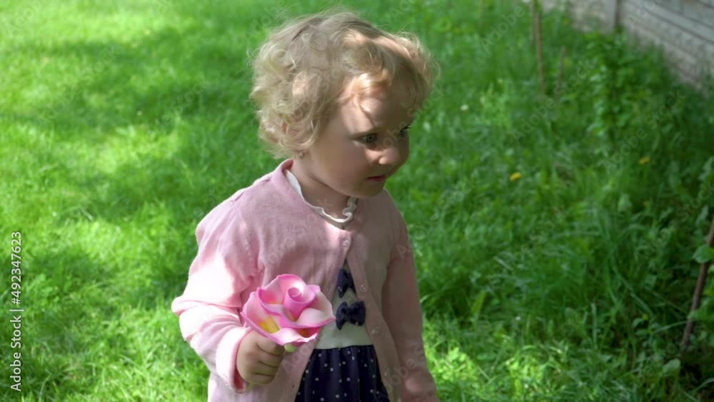 little girl with candies,summer little girl with candy in hand