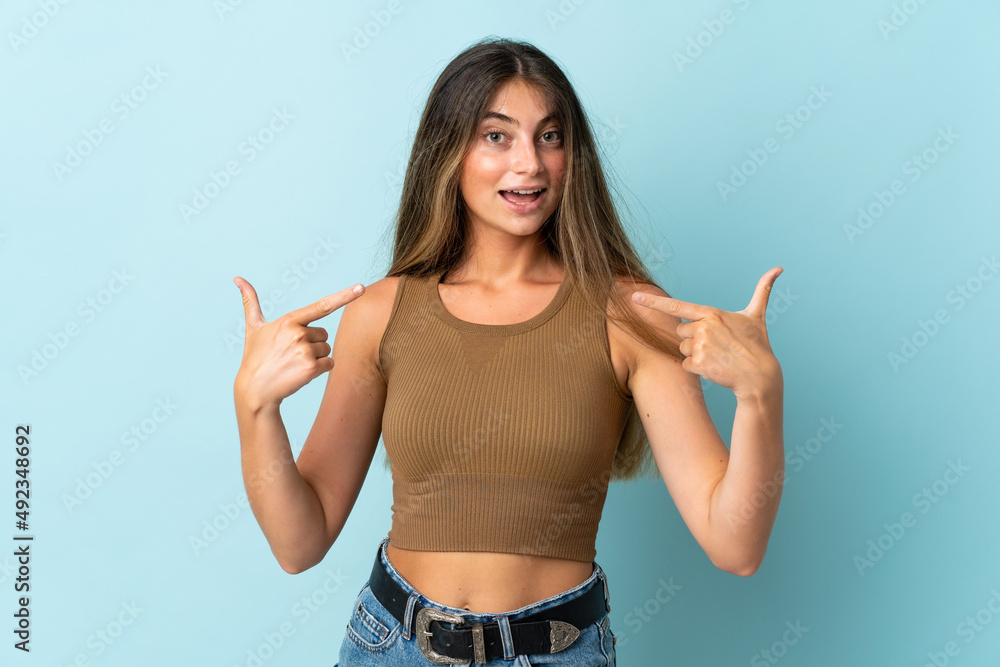 Young caucasian woman isolated on blue background giving a thumbs up gesture Young caucasian woman isolated on blue background giving a thumbs up gesture