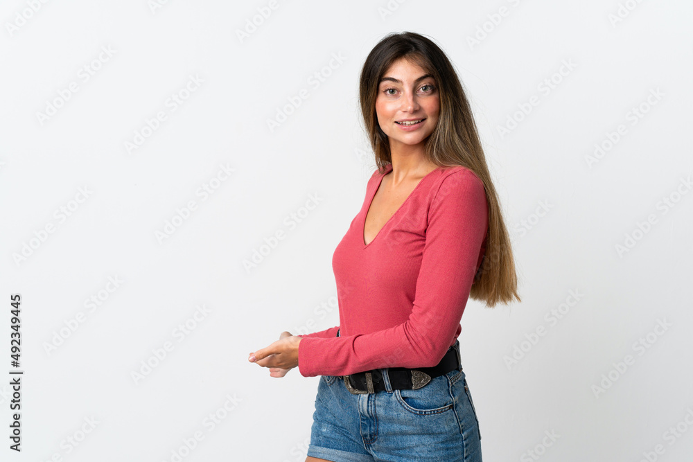 Young caucasian woman isolated on white background extending hands to the side for inviting to come Young caucasian woman isolated on white background extending hands to the side for inviting to come