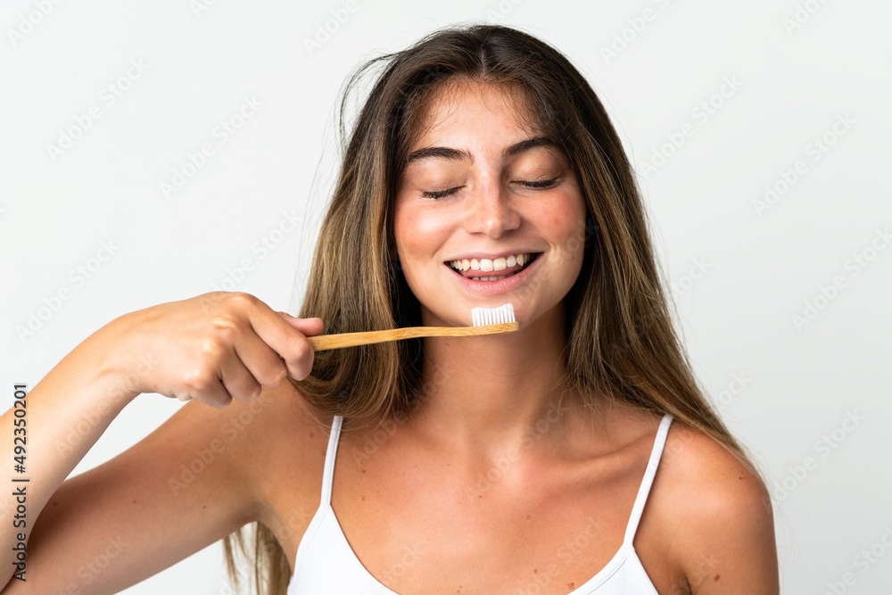 Young caucasian woman isolated on white background with a toothbrush and happy expression Young caucasian woman isolated on white background with a toothbrush and happy expression
