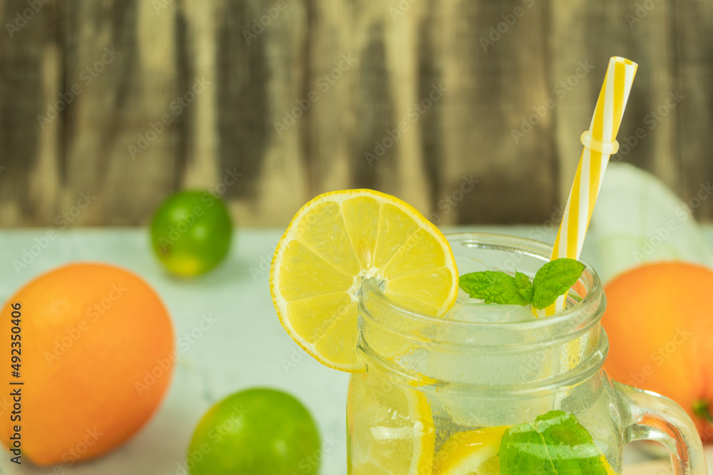 Fototapeta premium Fresh citrus lemonade with mint on a rustic background