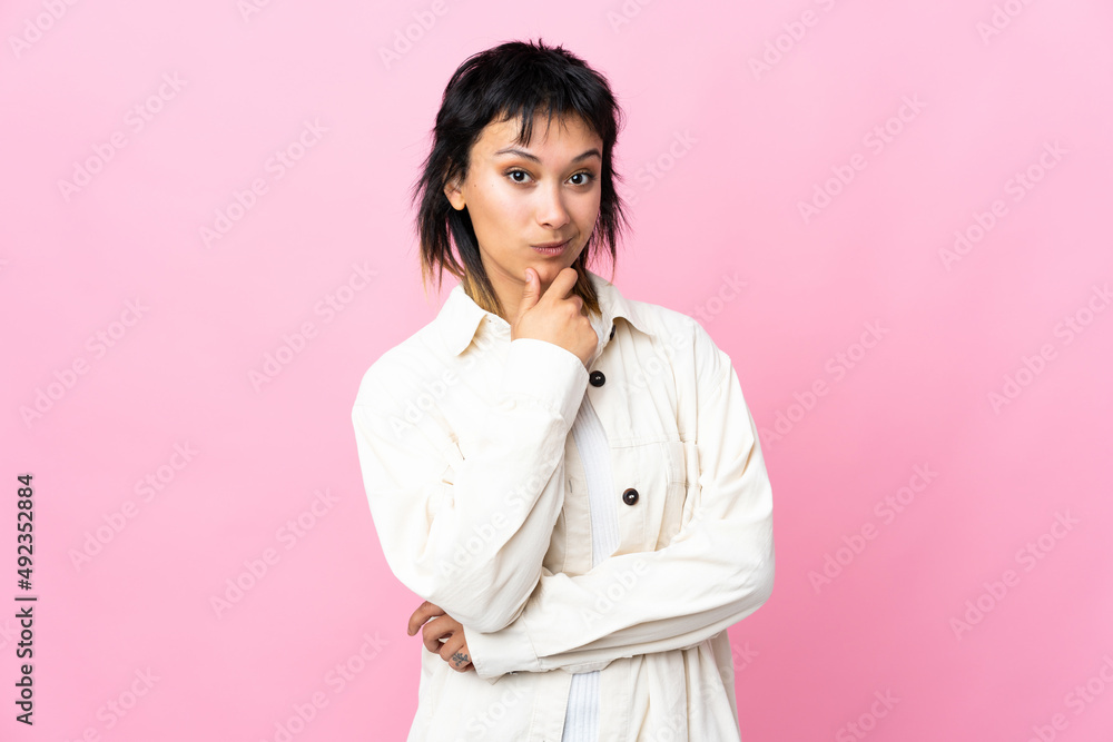 Young Uruguayan woman over isolated pink background thinking Young Uruguayan woman over isolated pink background thinking