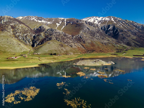 View of the mountain lake. Snowy mountains are displayed in a crystal clear lake. Lake Matese, province of Caserta Italy photo
