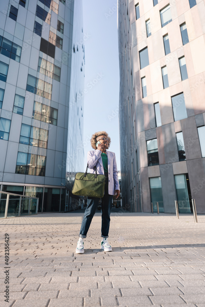 Successful black businesswoman or entrepreneur on cellphone. City business woman working Successful black businesswoman or entrepreneur on cellphone. City business woman working