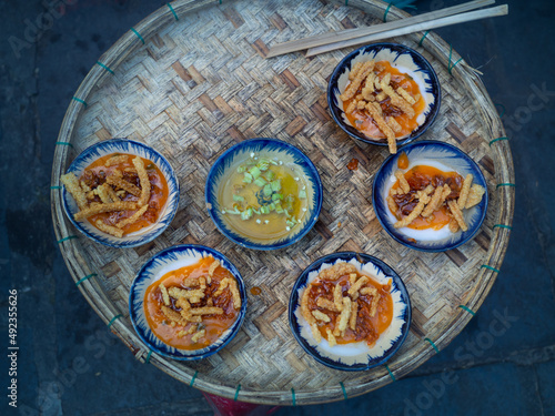 Bánh bèo (Steam Rice Cake) the famous street food of Hoi An, old town city. Must try menu for tourists. Steamed sticky rice cake with crispy dough with sweet and sour source.