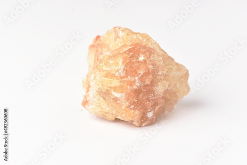 One uncut and rough Sunstone crystal,quartz on white