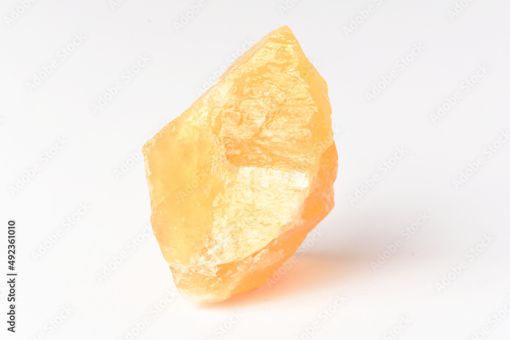 corundum stone  on a white background. yellow.