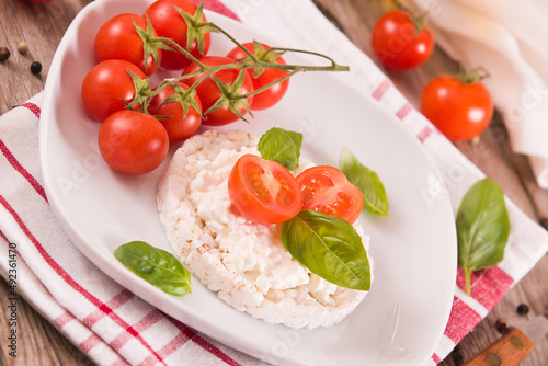 Rice cakes with milk flakes and tomato.