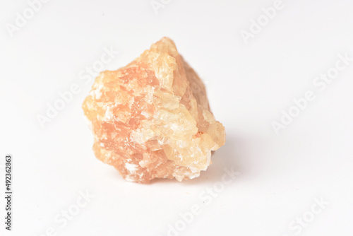 One  uncut and rough Sunstone crystal quartz on white