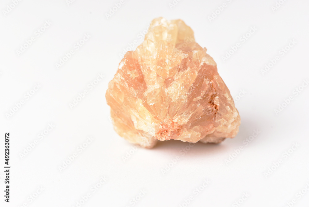One uncut and rough Sunstone crystal,quartz on white One uncut and rough Sunstone crystal,quartz on white